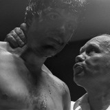 Referee Dave Brown checks on a dazed boxer.