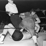 Referee Dave Brown and Tony Dowling pull Mike Mitchell from Jack Dombrowski who Mitchell has pushed through the ropes.
